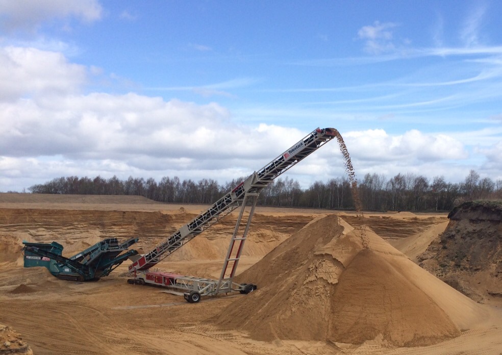 AggStack TCL Radial (110ft) tracked stacker stockpiling from mobile screen (1)